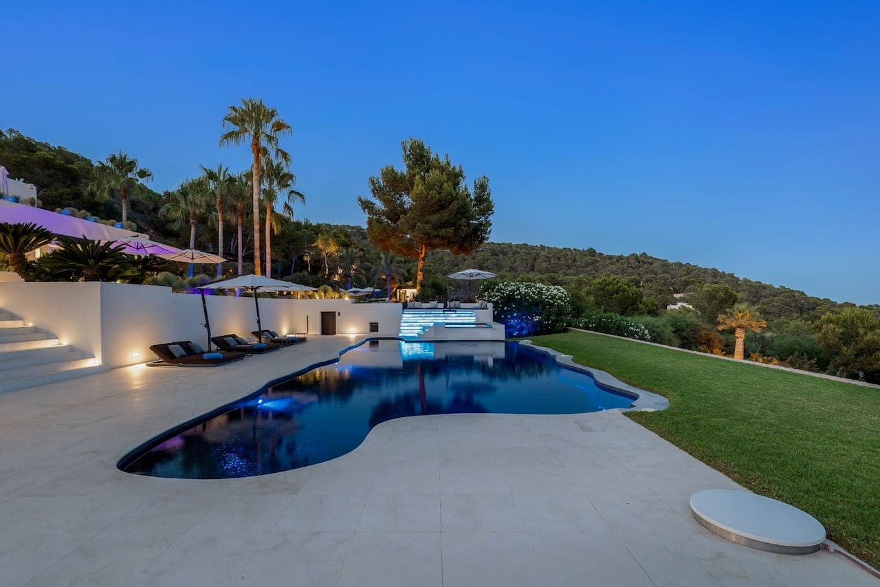 Dusk curved pool hillside casa incendio ibiza spain padel