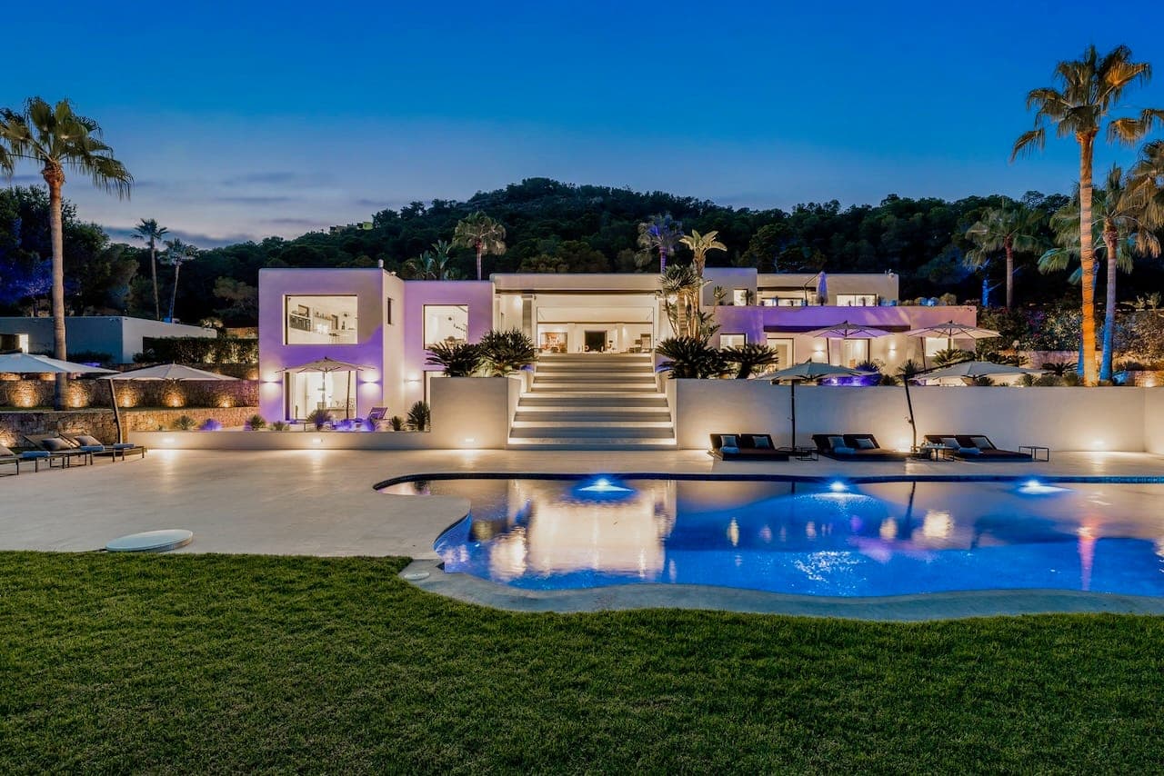 Dusk illuminated facade pool casa incendio ibiza spain padel