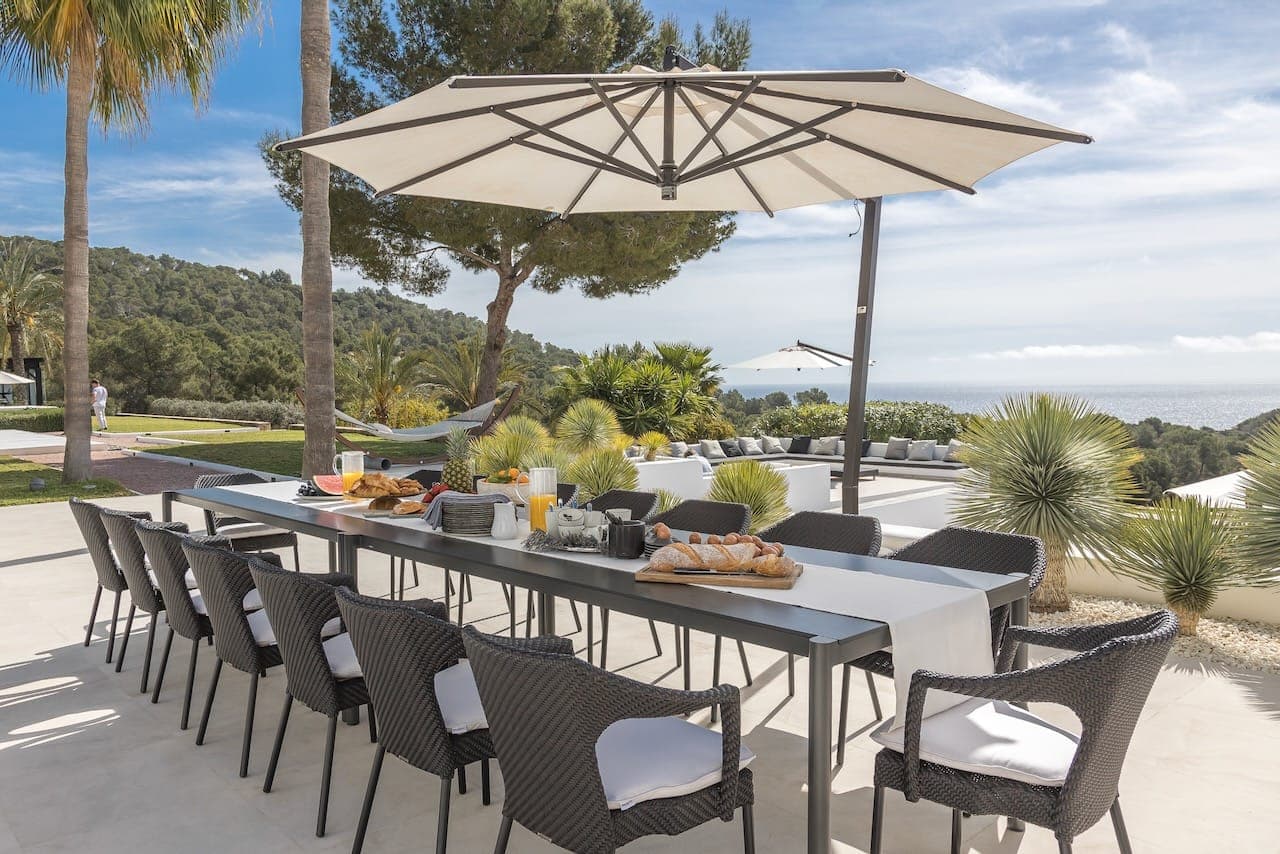 Outdoor dining cantilever parasol sea casa incendio ibiza spain padel