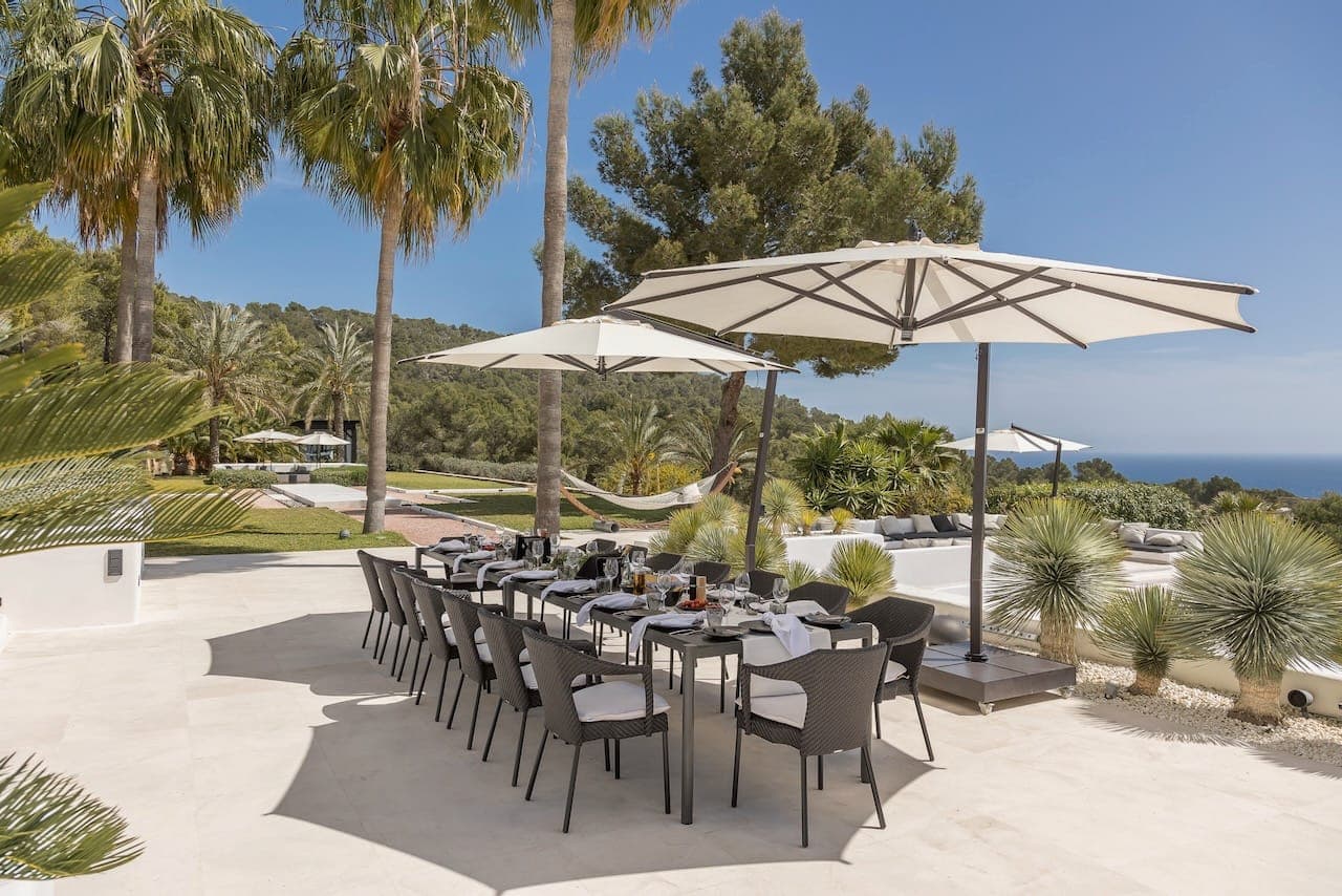Outdoor dining parasols palms casa incendio ibiza spain padel