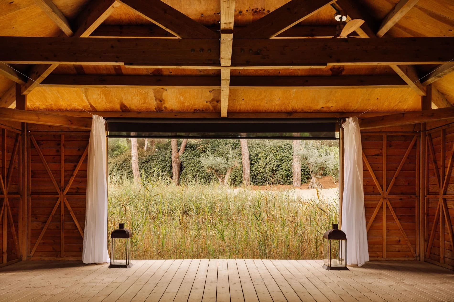 A covered deck looking out across the reed marsh