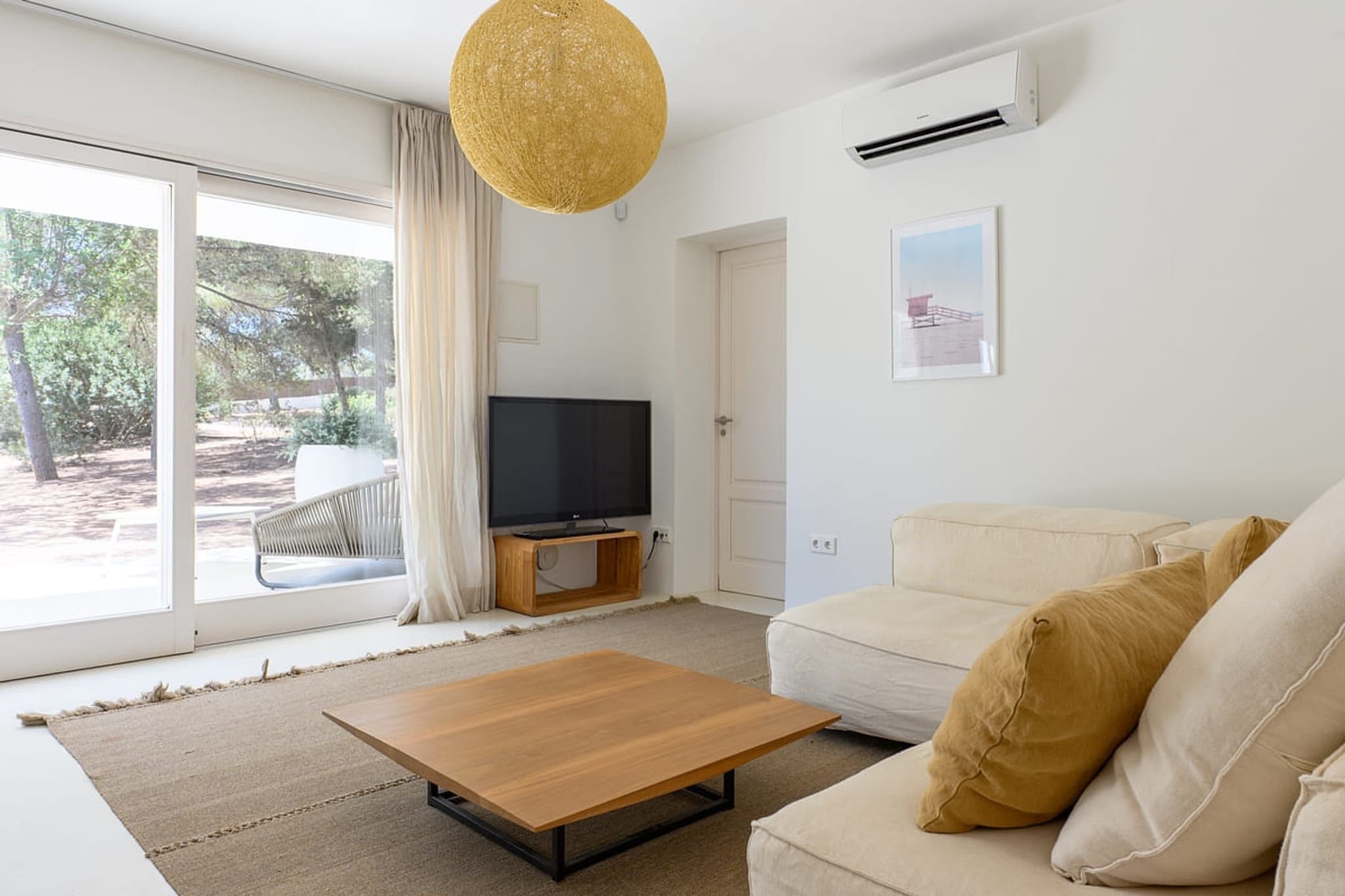 The living room under its globe pendant