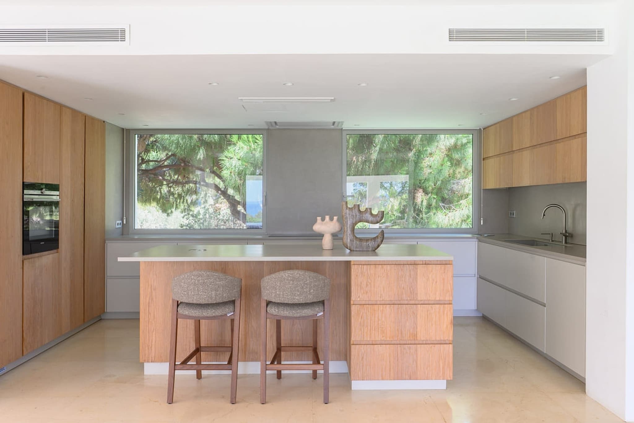 The kitchen island, stools along it