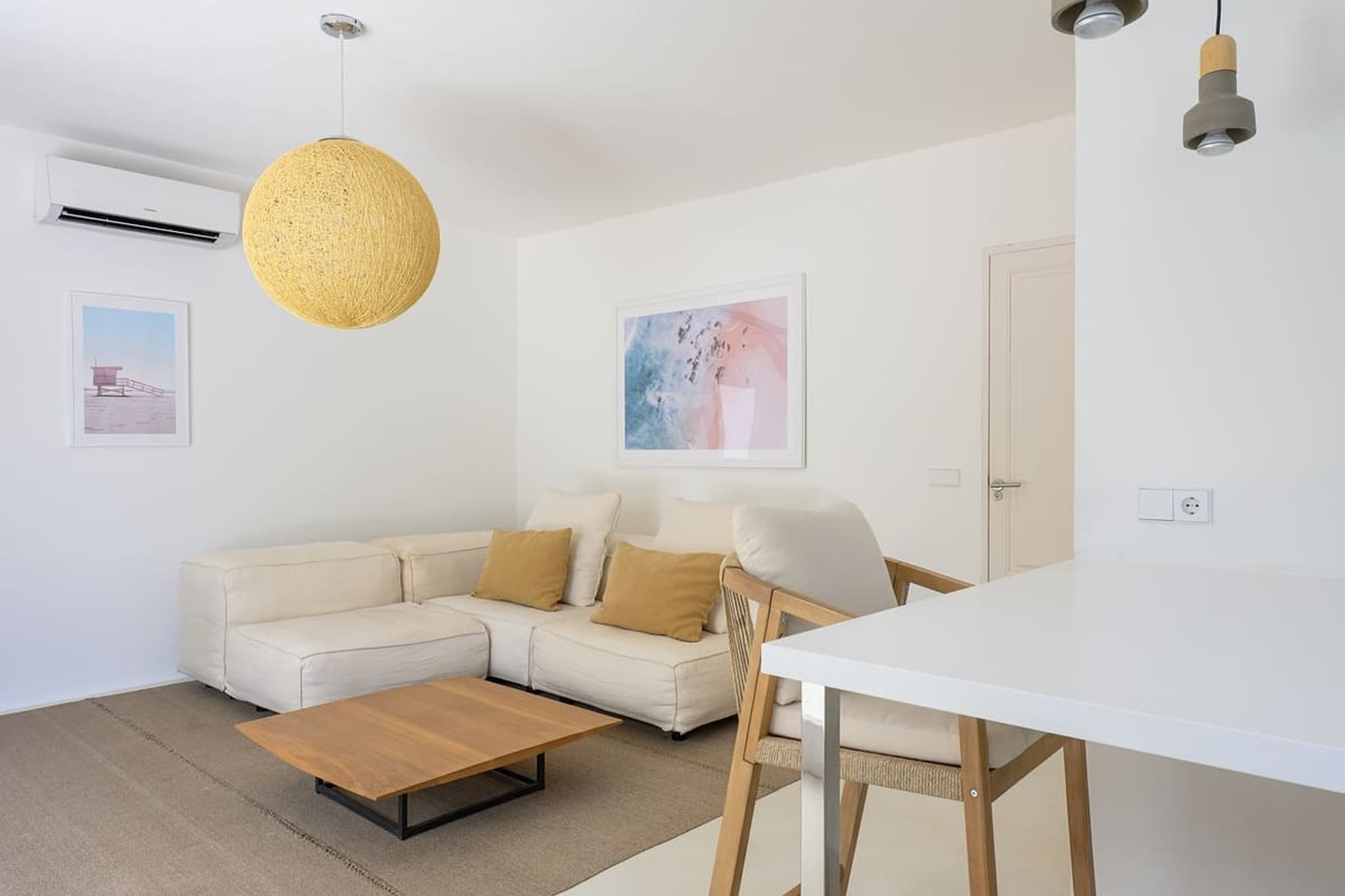 Living and dining in one room, the sofa between them