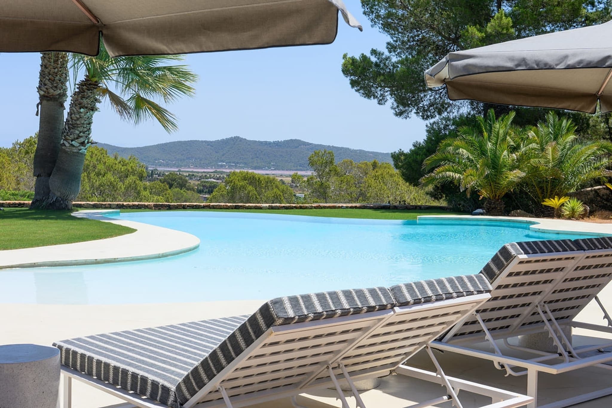 Loungers at the pool, the hills in front