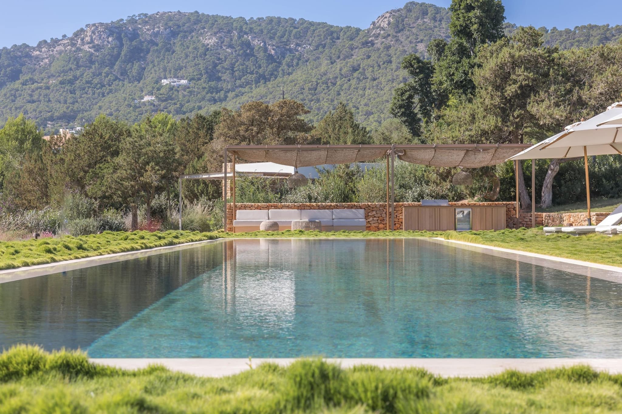 A saltwater pool with the mountains behind it