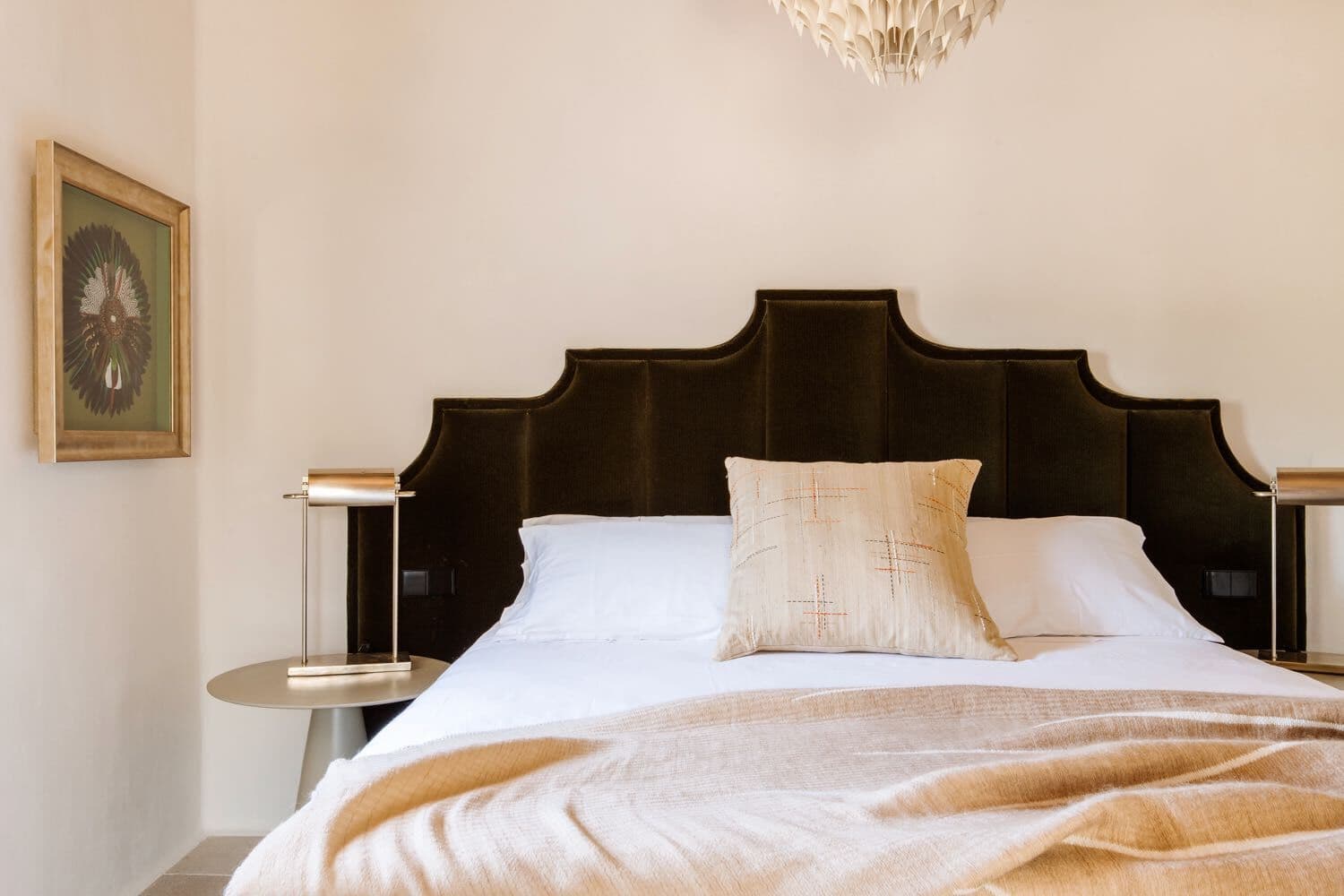 A black scalloped velvet headboard