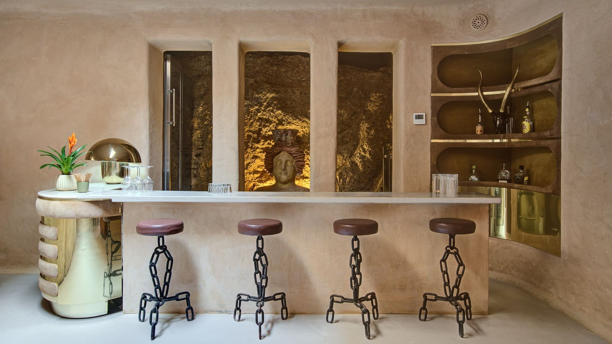 The brass bar and its leather stools