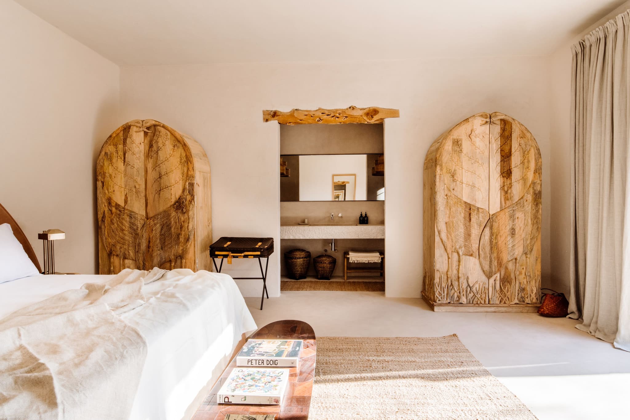 Carved wood wardrobes under an arch
