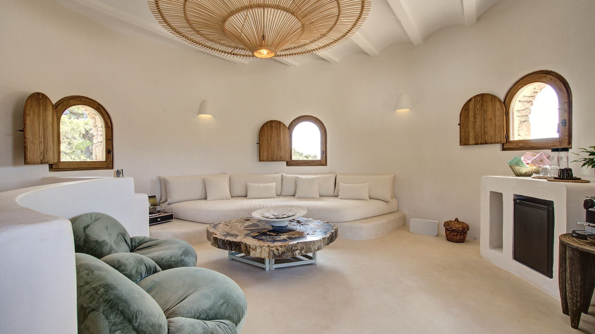 A curved built-in sofa under the arched windows