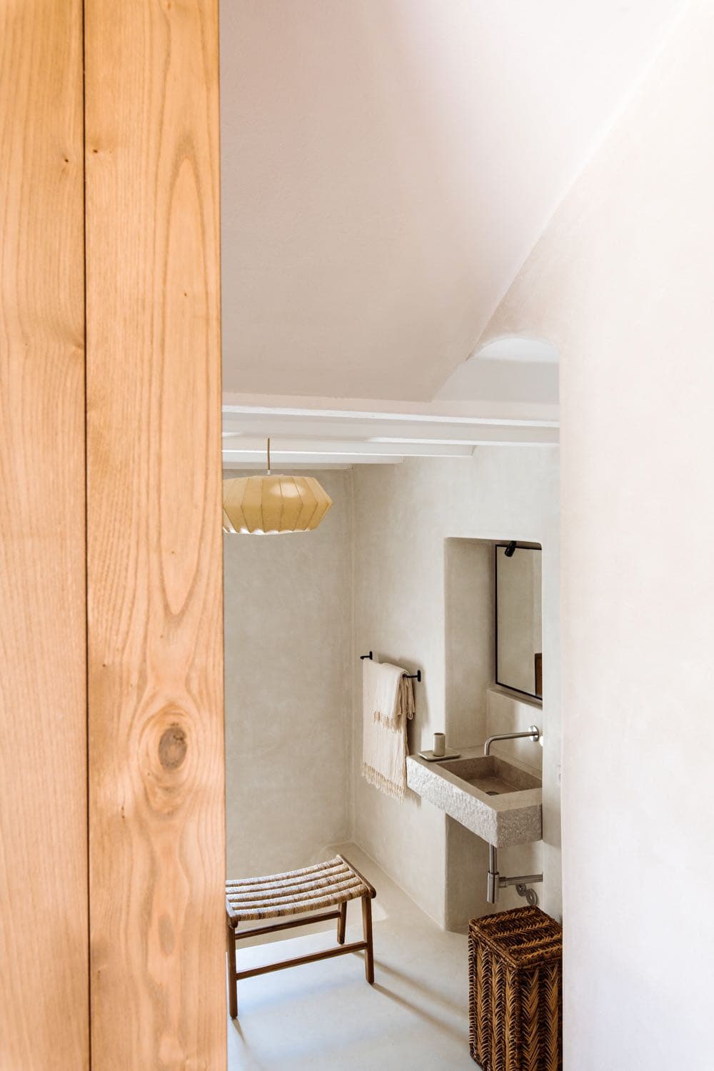 A stone basin in the microcement bathroom