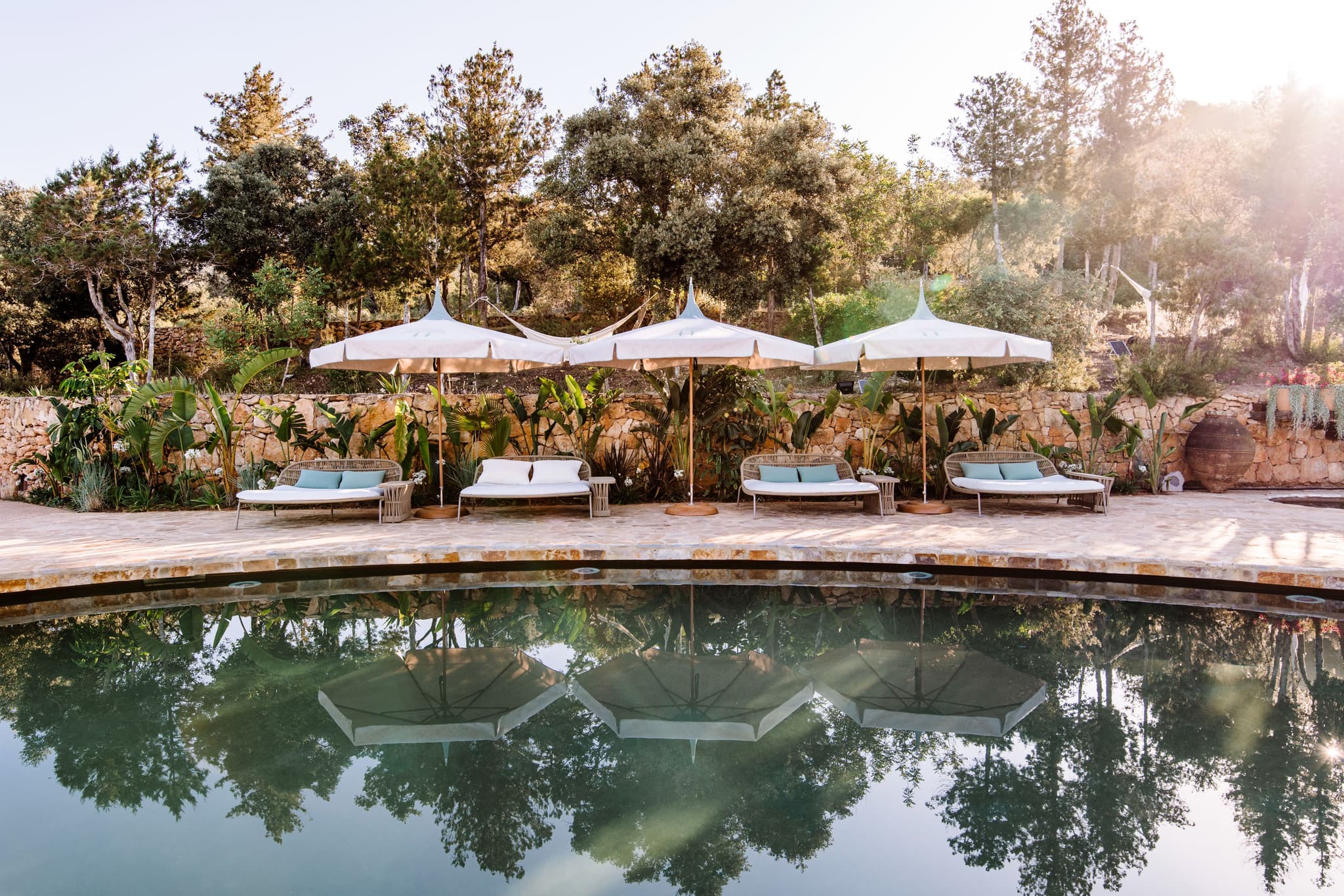 Pool loungers parasols golden light villa clarence ibiza spain padel