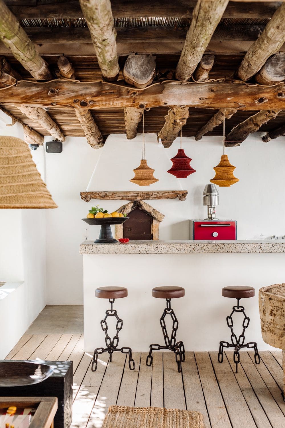 The whitewashed bar and its leather stools