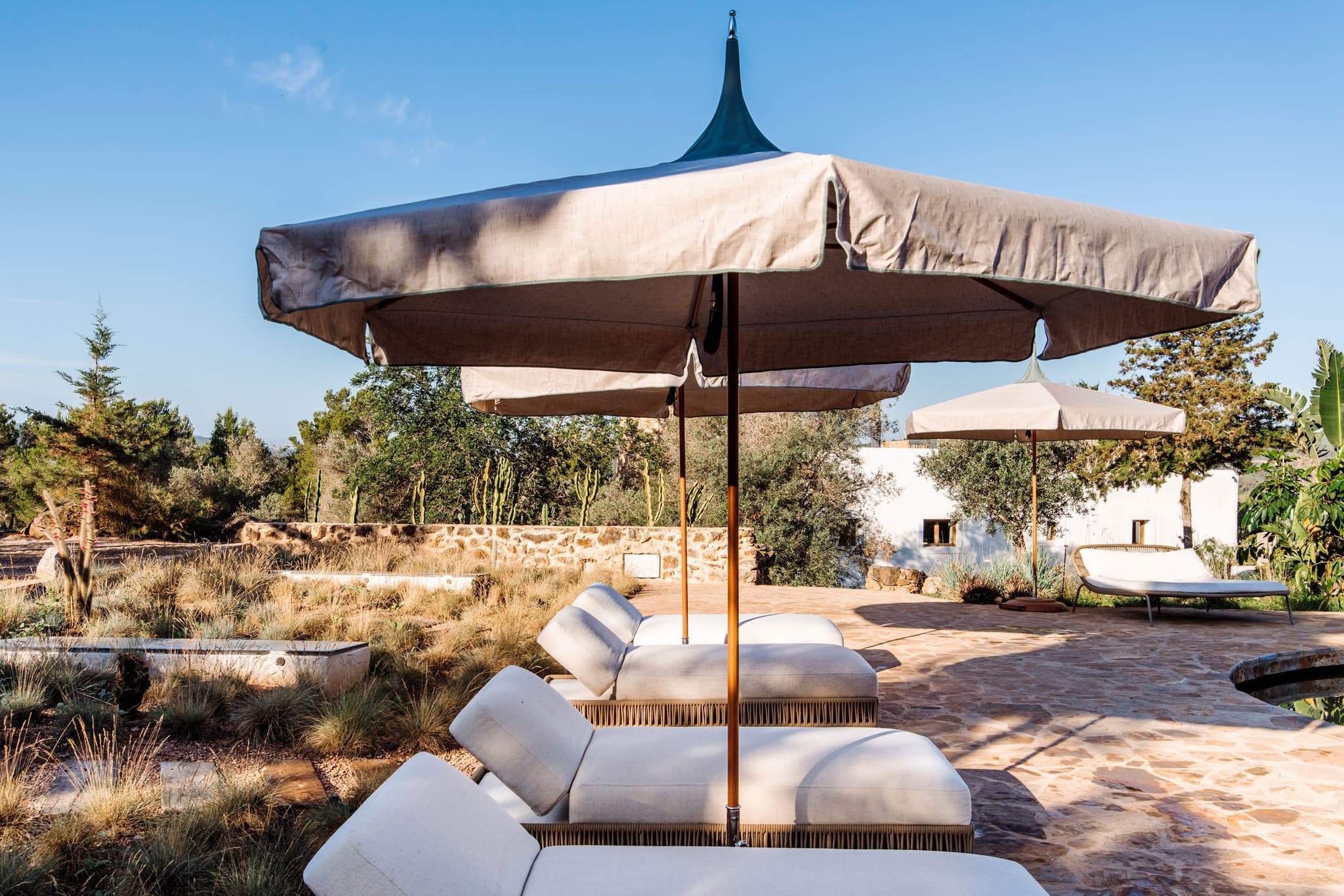 Sunloungers under a square parasol