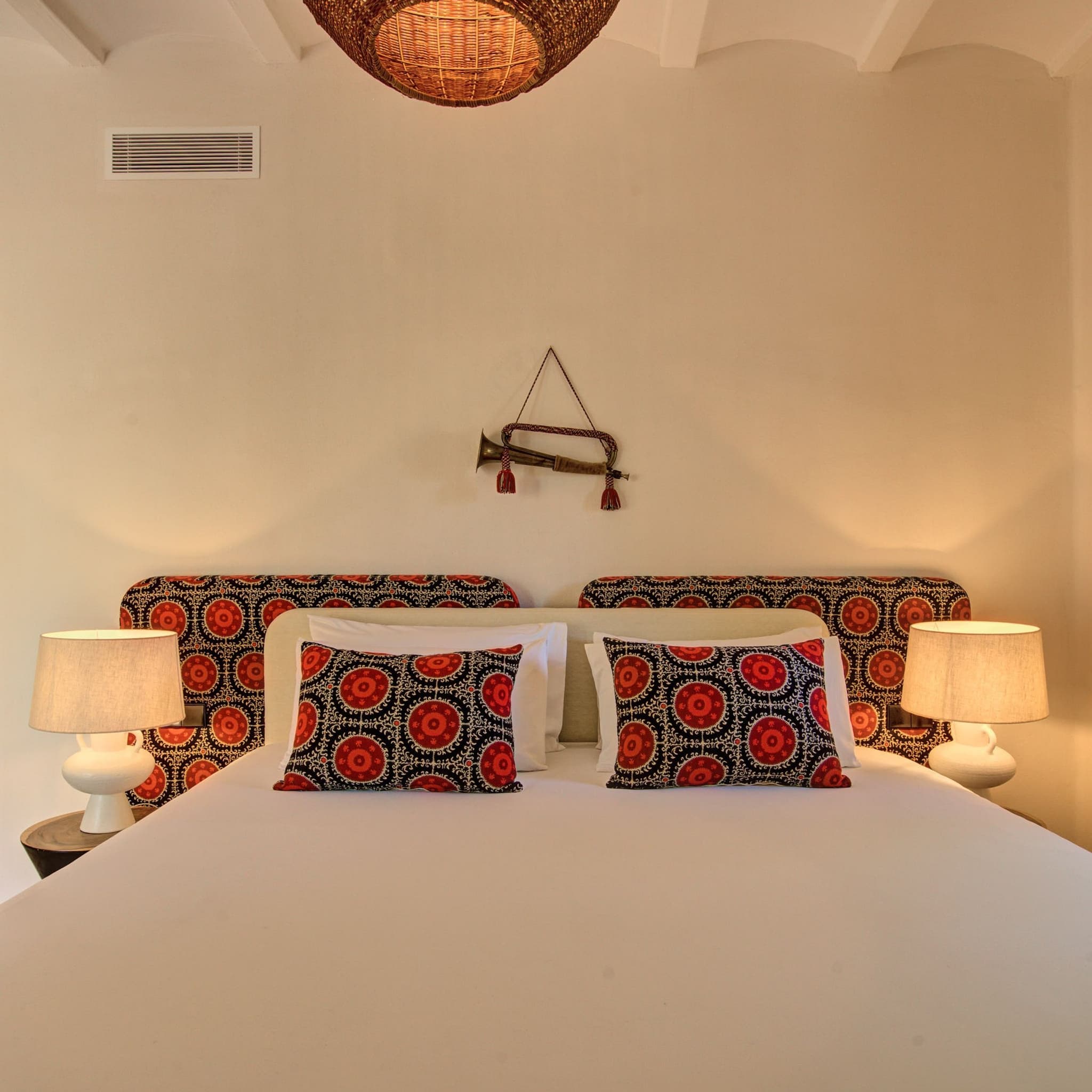Suzani headboards and red pillows