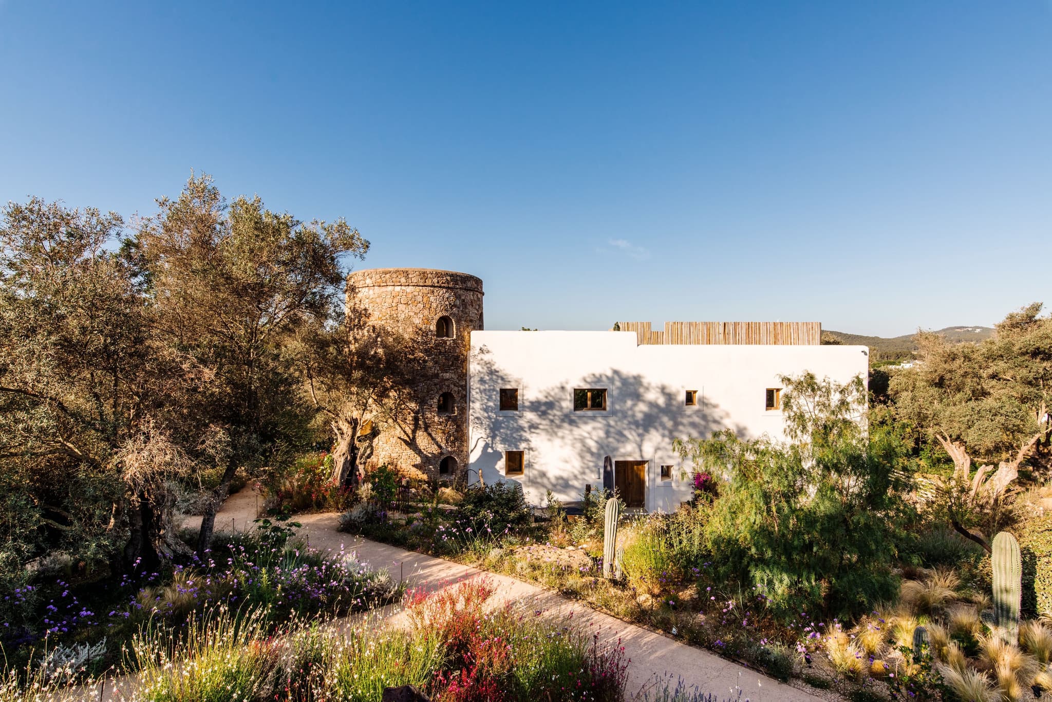 The whitewashed farmhouse and its stone tower