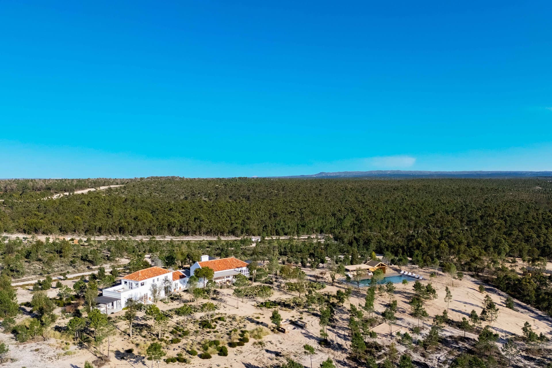Villa Kaba from the air, the house and its court held in the pine forest