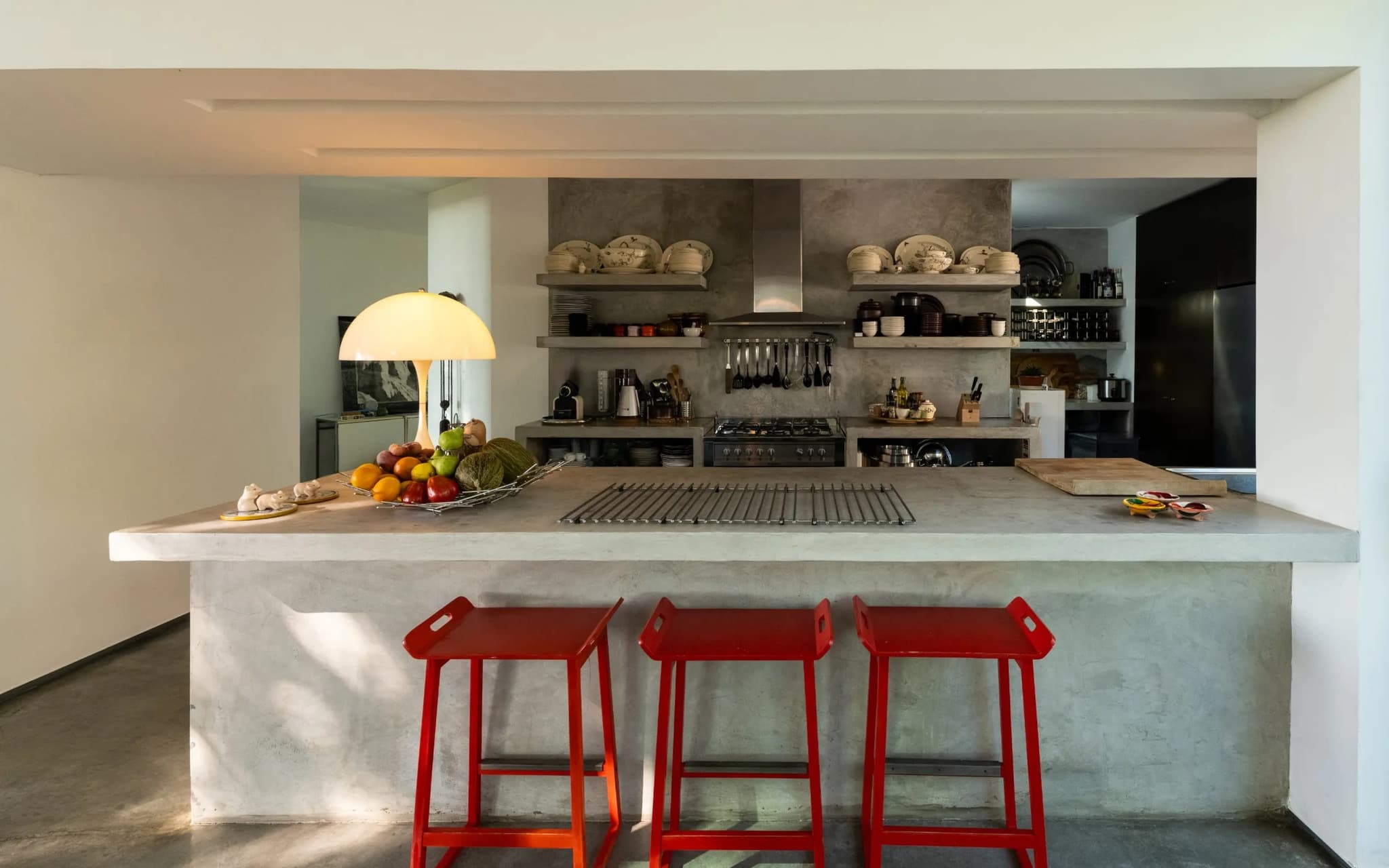 Concrete kitchen island red barstools villa lapa comporta portugal padel