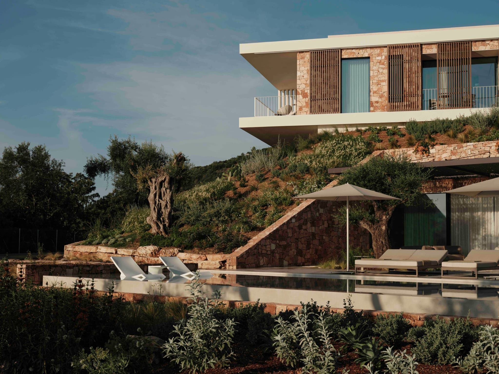 A terraced villa with its pool, in hillside gardens