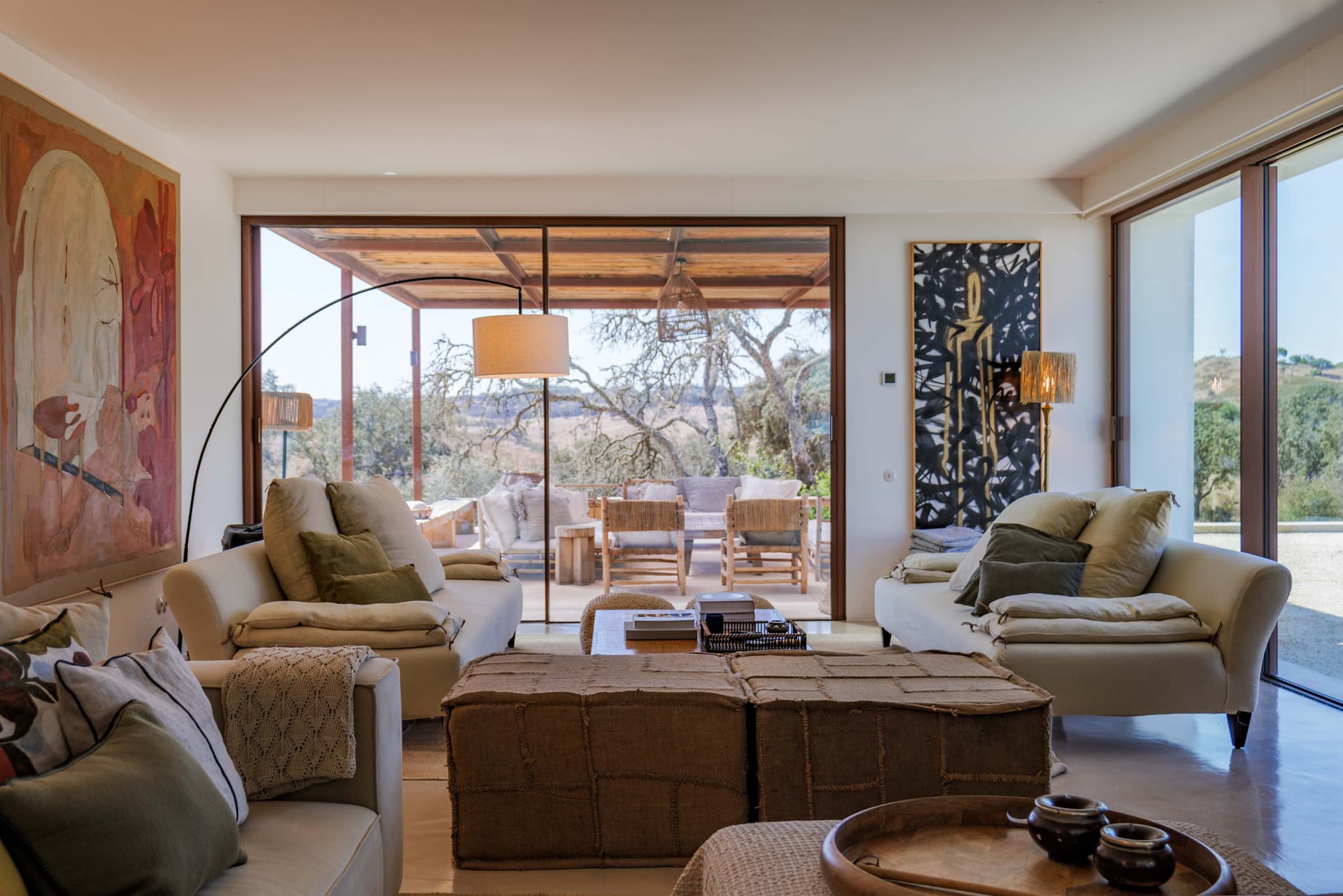 Living room sofas under the artwork, looking out to the terrace