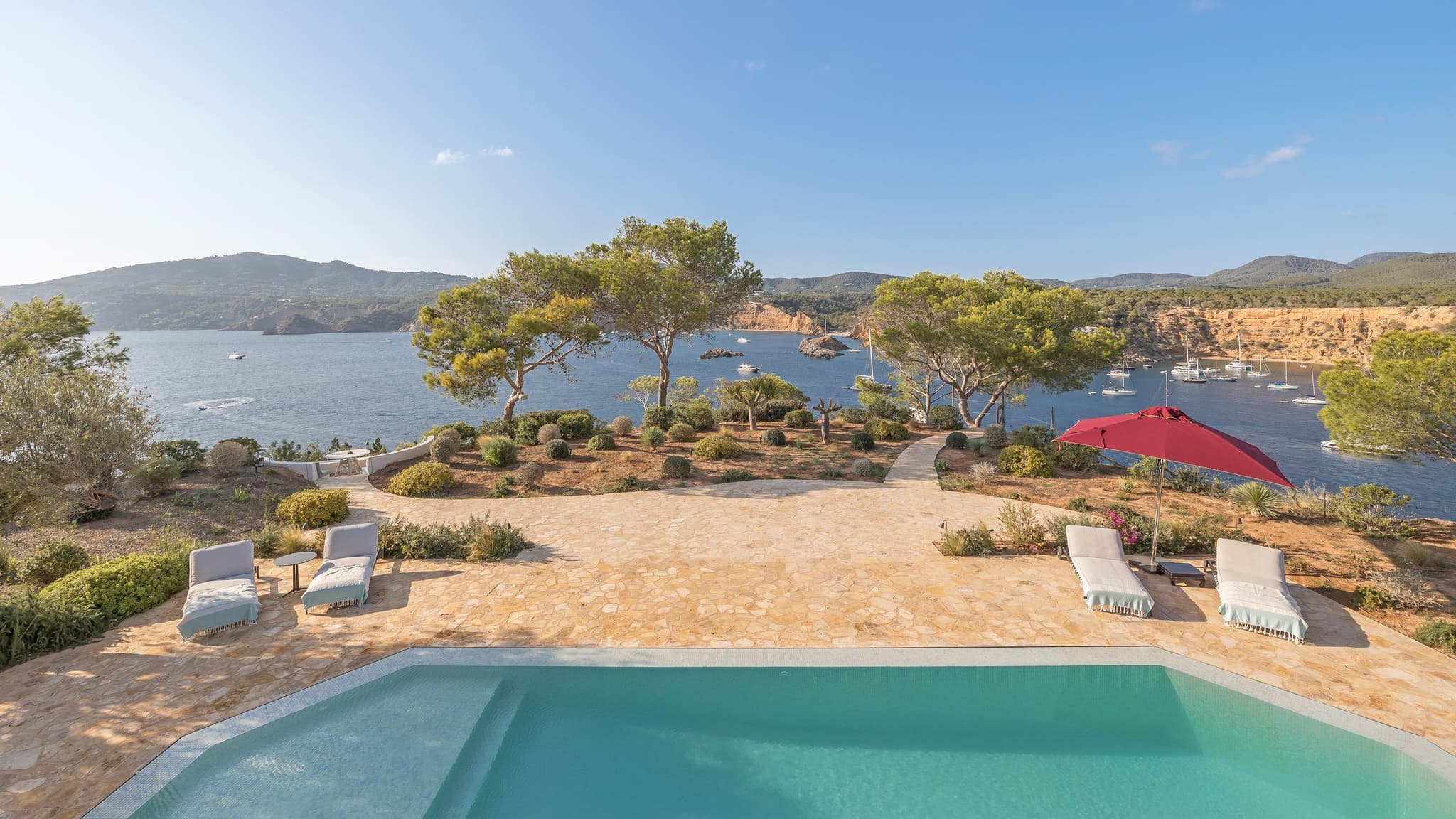 A pool on a clifftop, the cove and the open sea beyond it