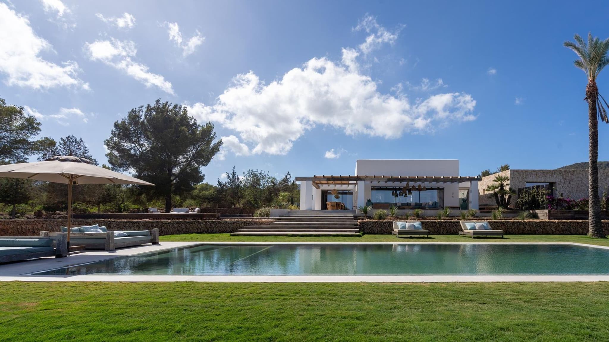 The saltwater pool along the front of the house